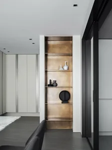 Modern minimalist kitchen featuring metal shelves adorned with contemporary art.