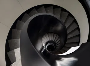 A spiral staircase made of black metal.