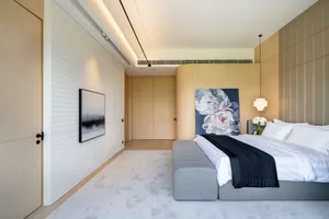 Minimalist bedroom featuring textured materials and white bedding.