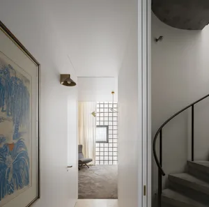 A modern residential entryway featuring concrete and glass material