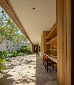 Modern house exterior featuring a wooden façade and outdoor seating area.