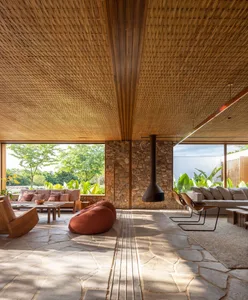 Modern living room with wooden ceiling and stone floor