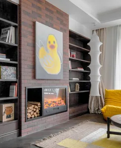 A modern living room featuring a brick wall, bookshelves, a fireplace, and a yellow couch.