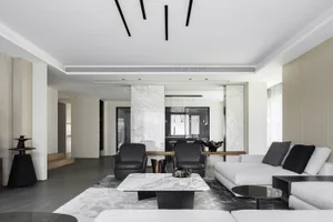 Modern living room featuring marble accents, wooden furniture, and leather chairs.