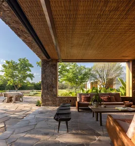 A modern living room featuring stone and glass materials with a comfortable seating area.