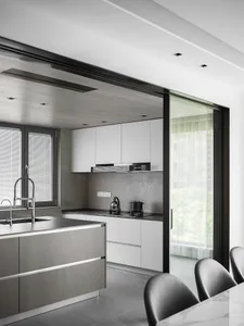 Modern minimalistic kitchen with concrete walls and white cabinetry
