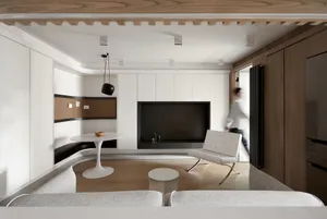 A modern minimalist living room with wood and white decor, featuring a white sofa, white side table, and white chair, with a 