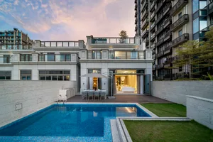 A modern residential exterior with stone and glass features.