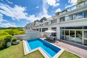 A modern residential property with a marble pool and patio area.