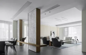 Modern living room with marble columns and furniture.