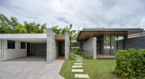 A modern house featuring brick and glass exterior materials.