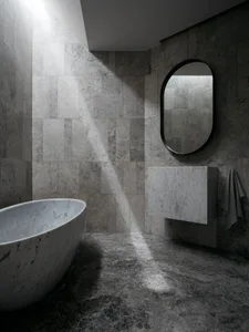 A modern minimalist bathroom with marble walls and floor, featuring a freestanding bathtub and a floating vanity.