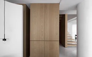 Modern minimalist hallway featuring wooden cabinets