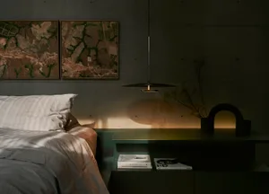A modern bedroom featuring concrete and water materials.