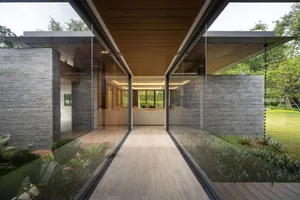 Modern exterior design featuring brick and glass materials, showcasing residential architecture.
