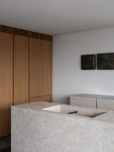 Modern kitchen interior featuring stone countertops and minimalist design.