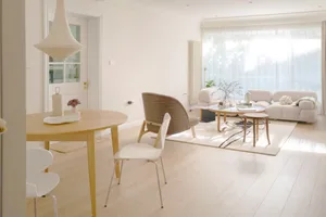 Modern living room featuring a bright, open space with wooden flooring and contemporary furniture.