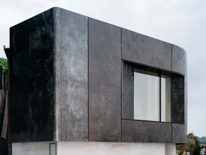 A modern building exterior made of metal material with a clean, sleek design.