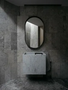 Modern minimalist bathroom with marble surfaces and a floating vanity.