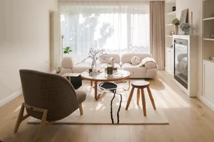 A cozy wooden living room with glass decor and plush seating arrangements.