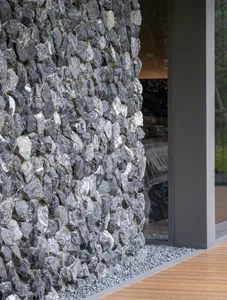 Modern building exterior featuring a stone wall