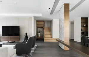 Modern living room featuring concrete and wood materials, with minimalistic decor and stylish furniture.