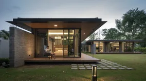 A modern house featuring glass walls and wooden accents.