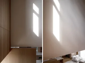 Interior design showcasing natural light through geometric window placements, contributing to a minimalist aesthetic.