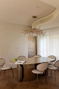 Modern dining room with a marble and metal table and chairs.