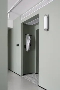 Modern interior design featuring a concrete finish wall and a coat hanger in the entryway.