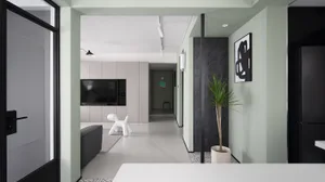 Modern living room with concrete flooring, white and black decor, and a white dog sculpture.
