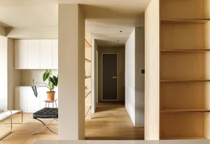 A minimalist interior with wooden elements, featuring a clean and modern design.