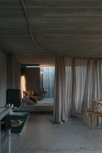 Modern minimalist residential interior with concrete, glass, and wood materials.