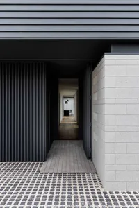 A modern exterior showcasing a concrete and stone material with a geometric design.