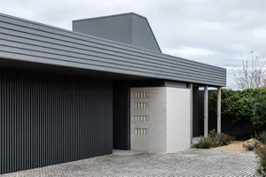 A modern house with a metal roof and metal wall panels