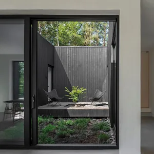 A modern outdoor space featuring wooden elements and metal chairs.