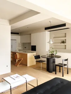 A modern kitchen with wooden finishes and minimalist design elements