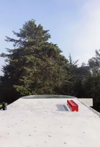Modern roof deck with red seating area and glass roof