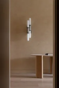 A minimalist interior showcasing wooden elements, concrete accents, and modern lighting against a beige textured wall.