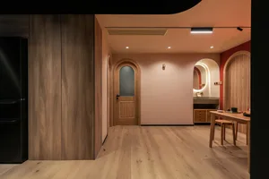 Image of a minimalist residential lobby with wooden features and a warm, inviting atmosphere.