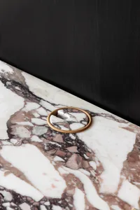 Modern interior design featuring a marble object with a circular detail.