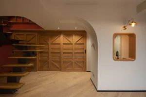 Modern interior design featuring a wooden entrance door and staircase