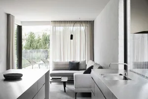 Modern living room with concrete flooring and minimalist design.