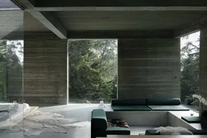 Modern minimalist living room with concrete walls, floor, and ceiling, featuring a green lounge area.