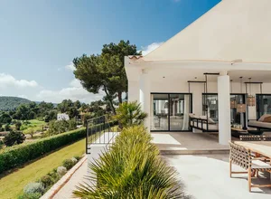A modern residential exterior featuring concrete and stone materials.