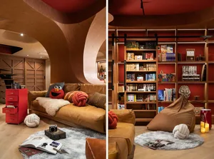 Modern living room with a wooden arch, leather sofa, and bookshelf.