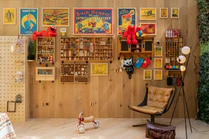 A wooden interior displaying various toys and vintage posters.