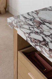 Close-up of wooden furniture with a marble top surface.