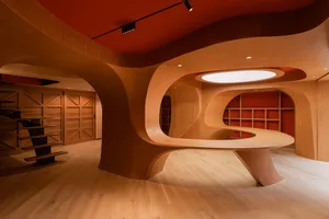 A modern restaurant interior with a wooden counter and curved wooden structures.