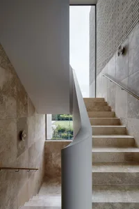Modern minimalist staircase with marble steps and glass railings